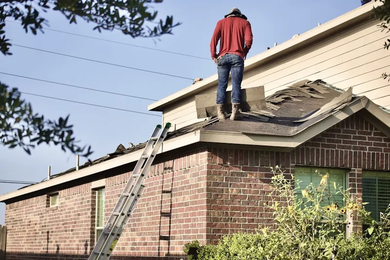 Professional roofer working on a residential roof in New Richmond